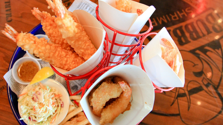 Fried shrimp served in baskets with paper cones, with bowl of coleslaw on the side