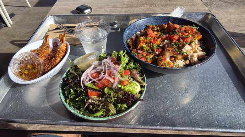 Selection of seafood dishes on metal tray