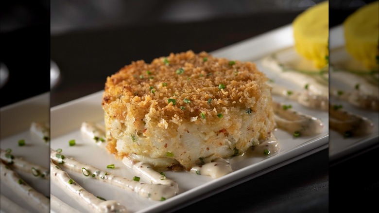 Crab cake on a plate with sauces