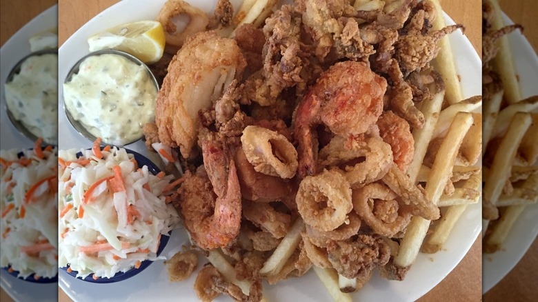 Fried seafood platter with fries and coleslaw