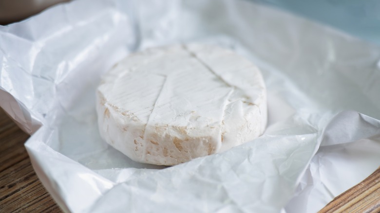 Unwrapped wheel of Camembert cheese