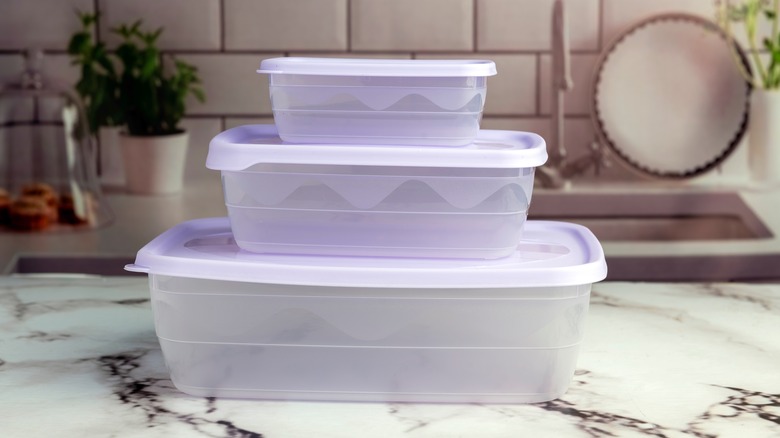 Three plastic food boxes stacked on kitchen counter