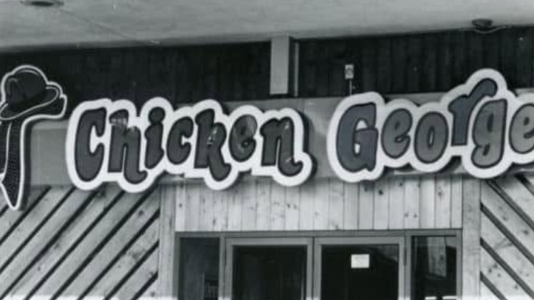 the storefront of a chicken george outlet in a black and white image