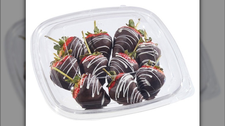 Chocolate hand dipped strawberries on a white background