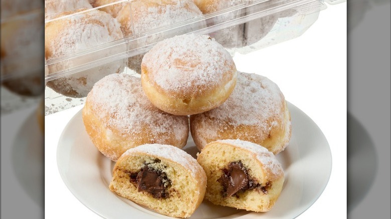 Mini beignets filled with chocolate hazelnut on a white background