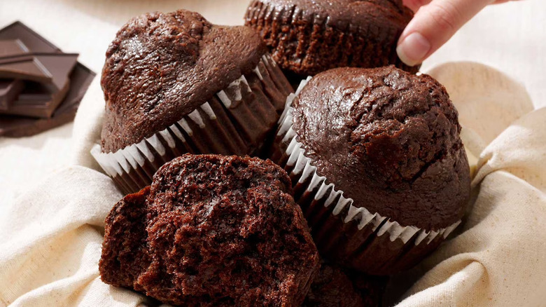 Rich chocolate muffins pictured with the liners.
