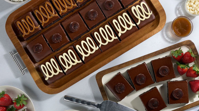 Top view of a tray of brownies decorated with frosting and drizzle.