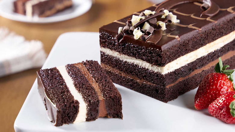 Moist tuxedo bar cake, with a piece cut off.