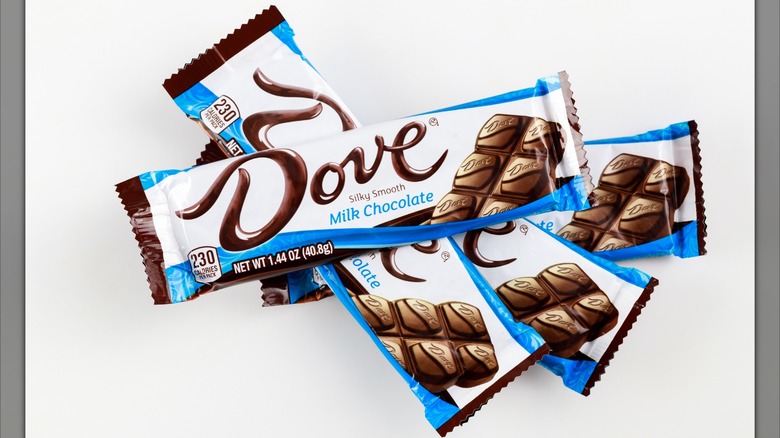 A fanned-out stack of Dove Milk Chocolate bars against a white background