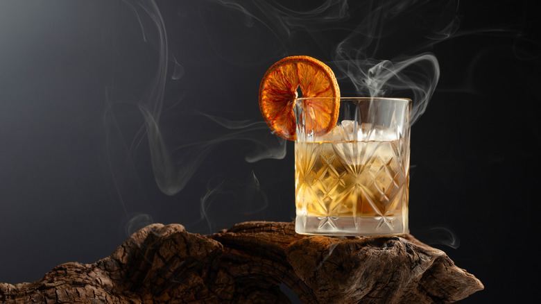 Old Fashioned cocktail on a piece of wood