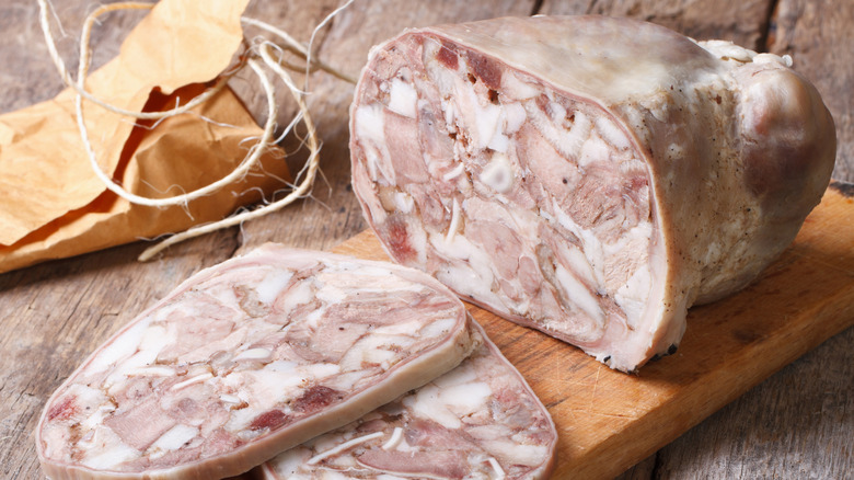 Cut headcheese on chopping board close-up