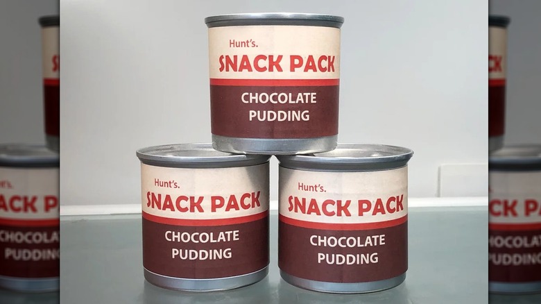 Mirrored image of three Hunt's Pudding cans stacked