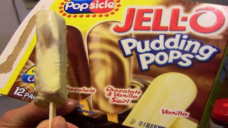hand holding pudding pop popsicle in front of Jell-o Pudding Pop box