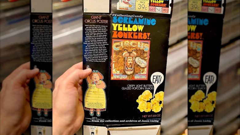 Mirrored image of hand holding Screaming Yellow Zonkers box