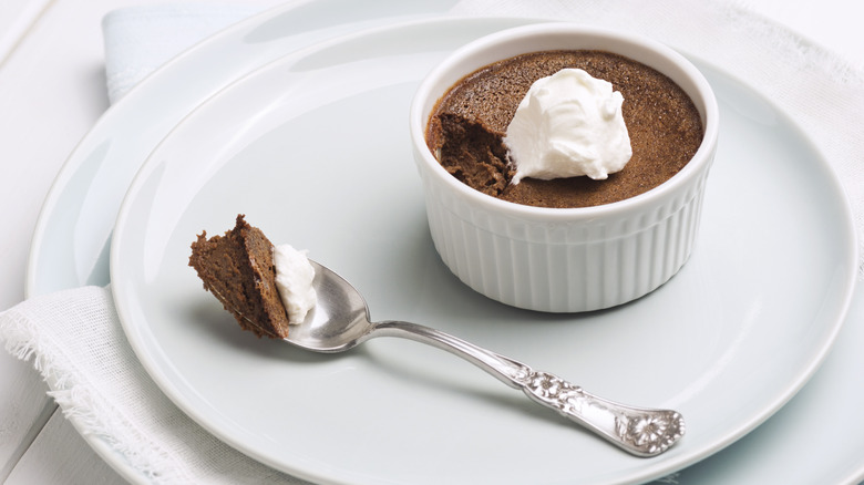 Small ramekin of chocolate pot de creme with a spoonful taken out