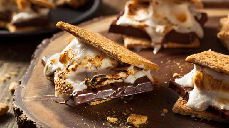 Homemade gooey s'mores plated on a wooden board