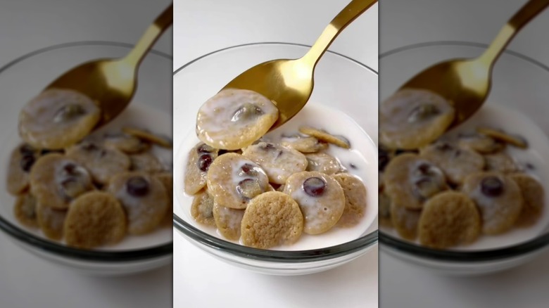 Spooning cookie cereal from bowl