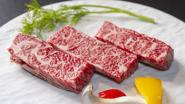Real Kobe beef on white plate with garnishes