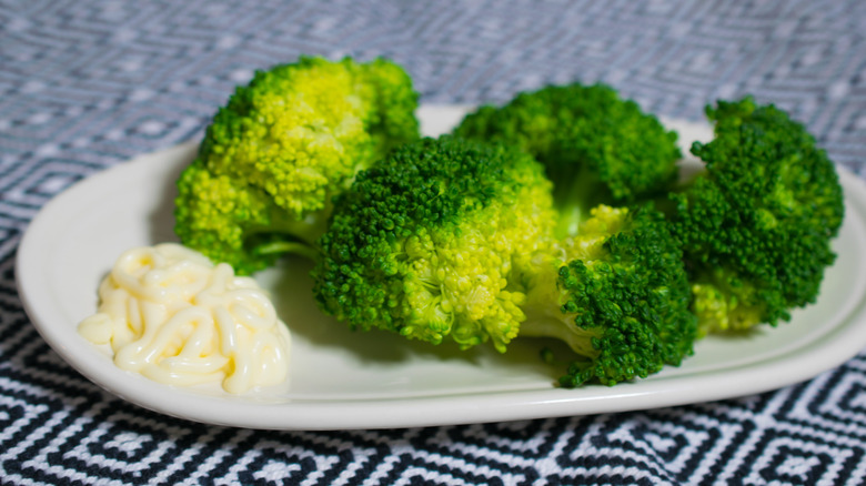Steamed broccoli on a white plate
