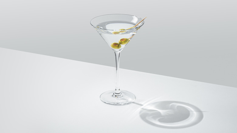 A martini in a glass with olives