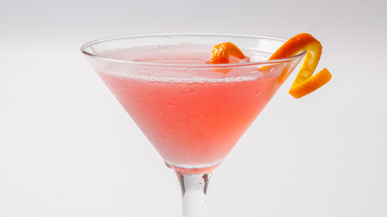 Cosmopolitan cocktail in martini glass with orange twist garnish