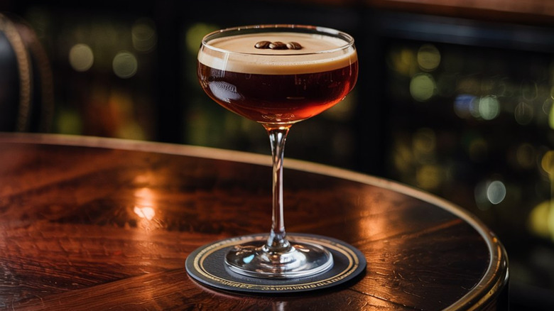 Espresso martini cocktail in coupe glass on table