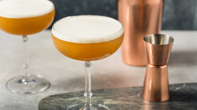 French martinis in coupe glasses next to copper cocktail measure and shaker