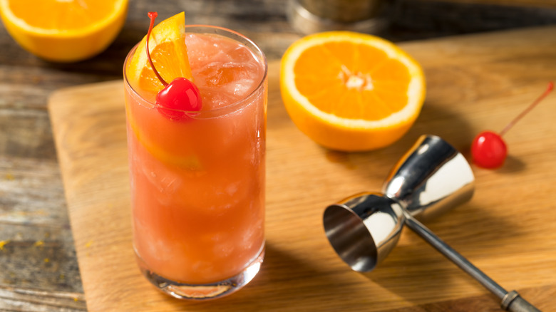 Sex on the beach cocktail garnished with maraschino cherry and orange slice