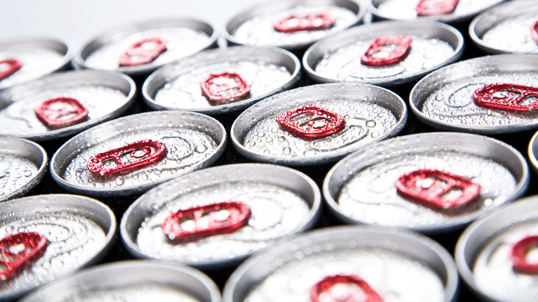 Tops of beer cans with red tabs