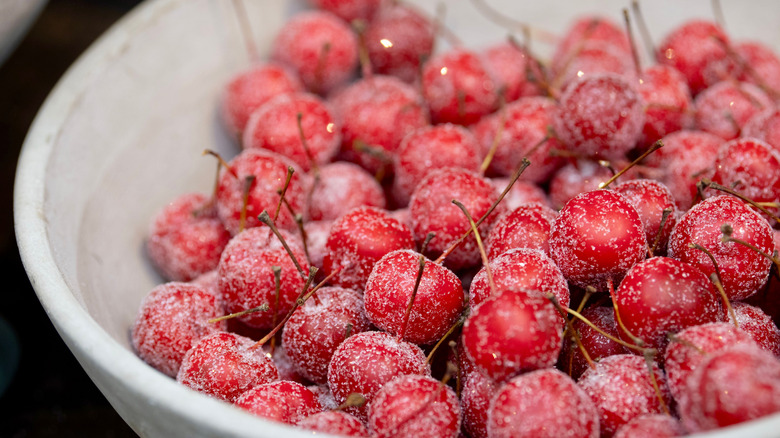 Frozen cherries in white bowl