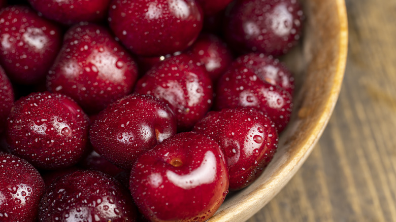 Wet cherries in wooden bowl