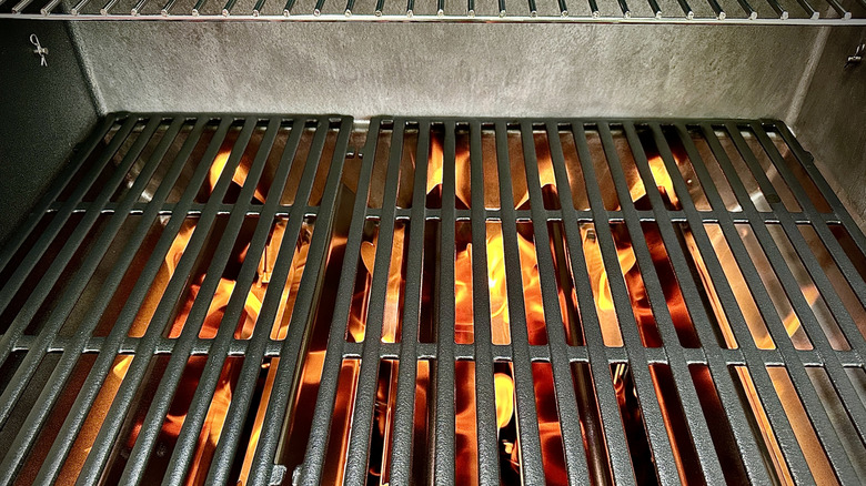 a gas grill with very clean grates and interior, preheating before cooking