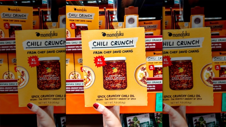 Hand holding Momofuku Chili Crunch at Costco