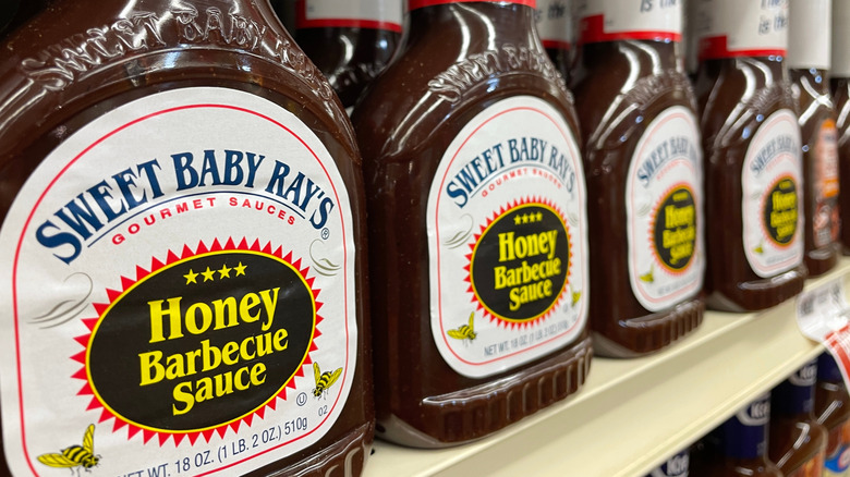 Bottles of Sweet Baby Ray's BBQ Sauce lined up on store shelf