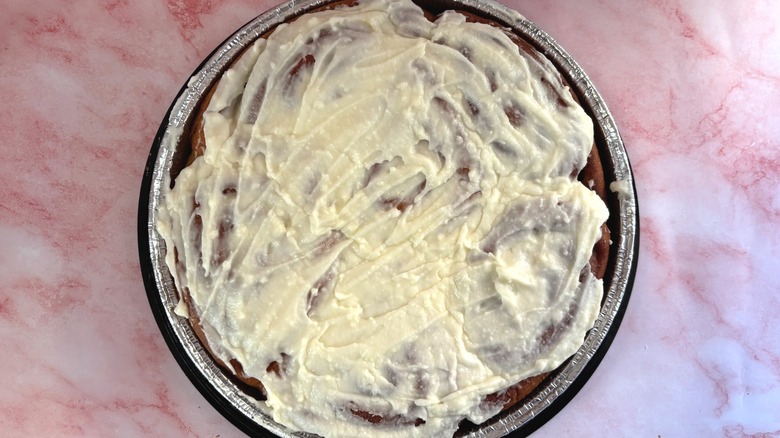 Overhead shot of tray of Costco cinnamon rolls on pink surface
