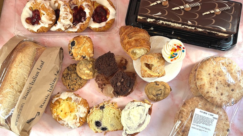 Top-down shot of an array of Costco bakery items on pink surface