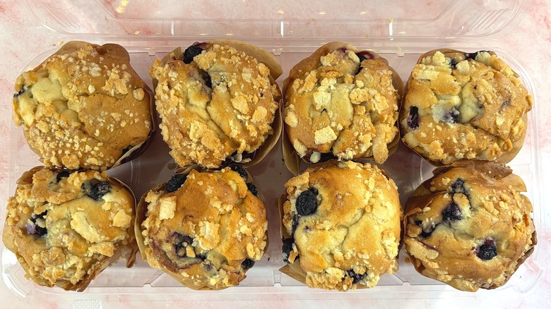 Overhead shot of box of blueberry cream muffins from Costco on pink surface