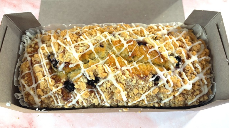 Overhead shot of Costco lemon blueberry loaf in box on pink surface