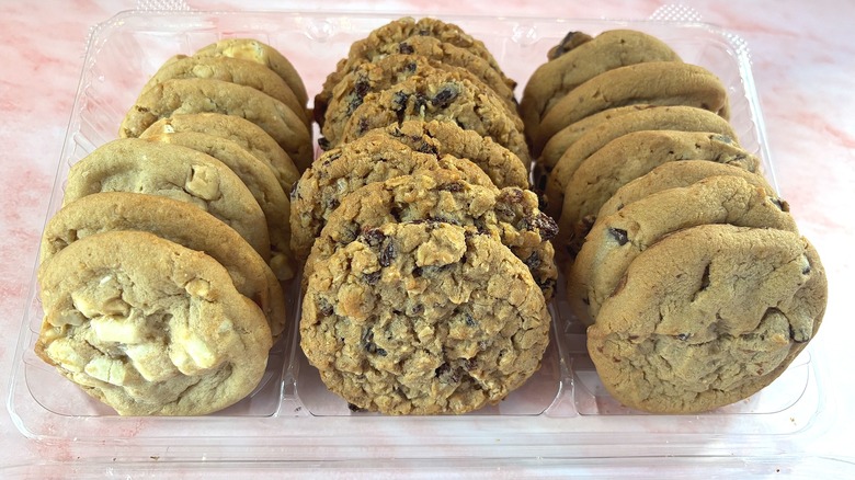 Box of Costco variety cookies on pink surface