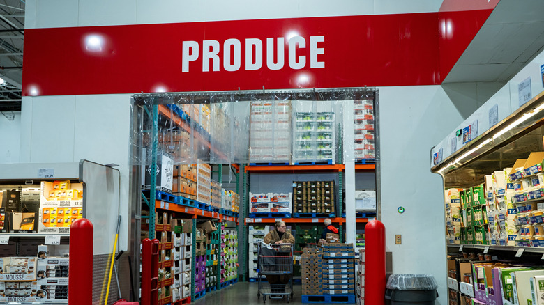 View of Costco produce section entrance with stacked fruits and vegetables