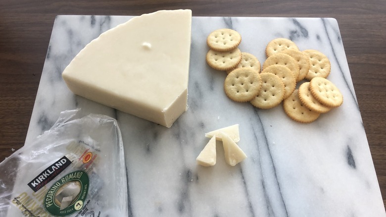 Kirkland Signature Pecorino Romano cheese on platter with crackers.