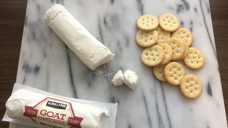 Kirkland Signature goat cheese on planner with crackers.