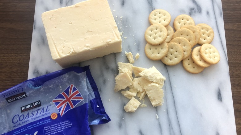 Kirkland Signature mature English cheddar on platter with crackers.