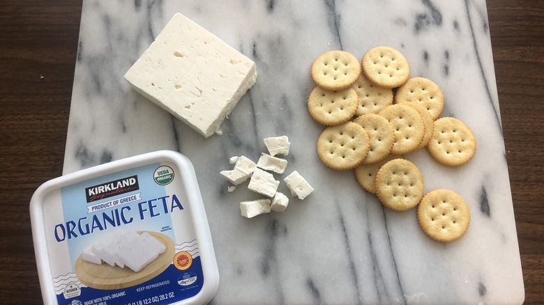 Kirkland Signature organic feta on a board with crackers.