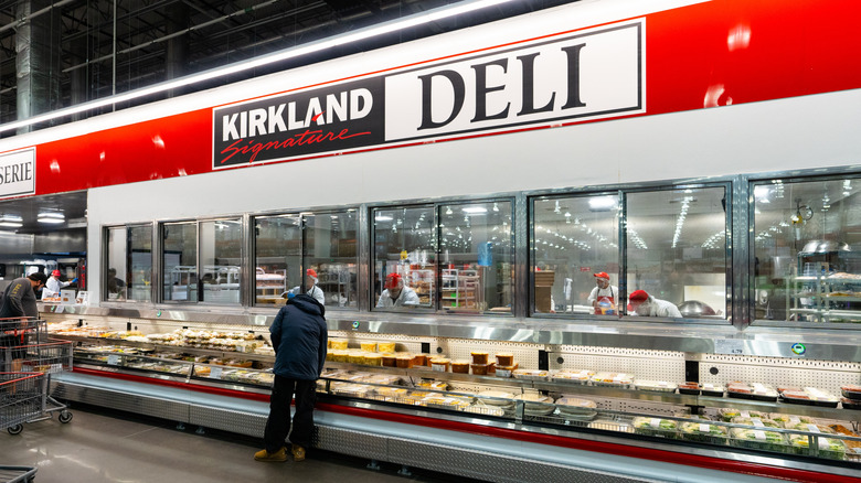 Wide shot of Costco deli counter under Kirkland Signature deli sign