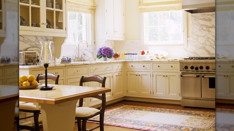 Light yellow kitchen with an ornamental rug
