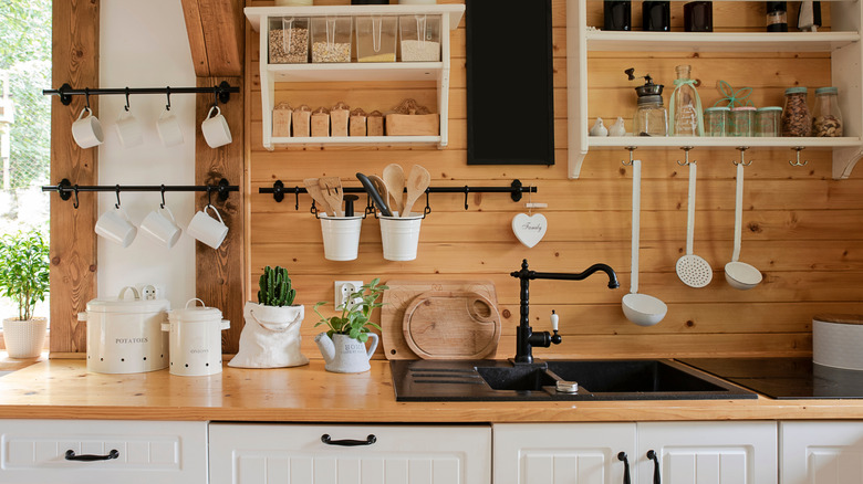 Cabin-like kitchen with shiplap walls and open storage