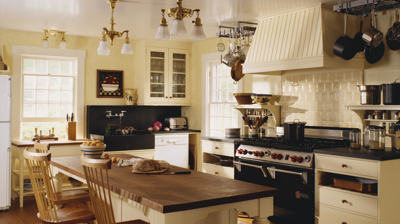 Large old-fashioned kitchen with golden light sconces