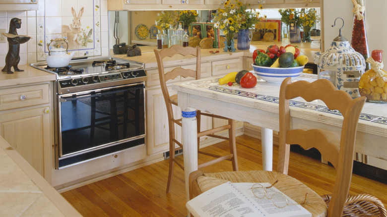 Light wooden kitchen with a bunny motive for stove backsplash