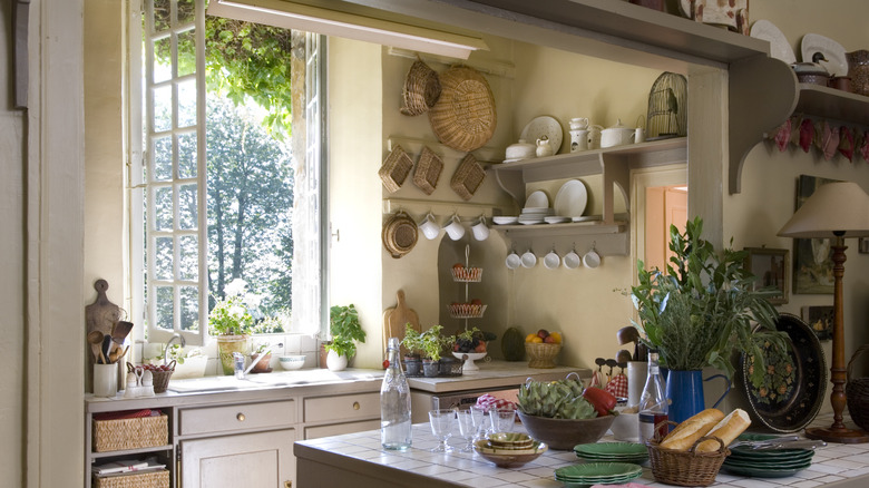 Tall French window, wide open in an old-fashioned kitchen